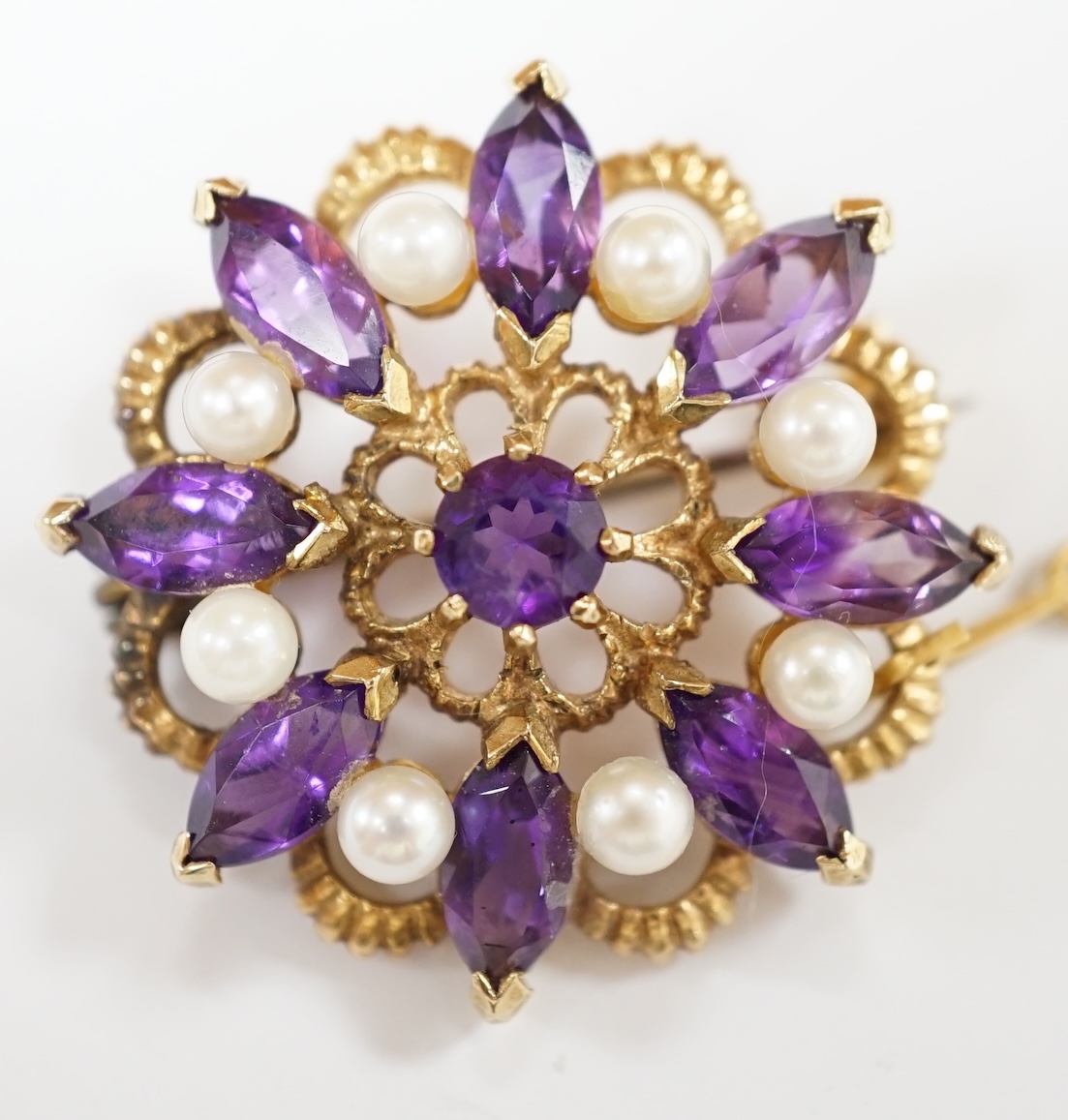 A 1970's 9ct gold, amethyst and cultured pearl cluster set circular brooch, 28mm, gross weight 7.1 grams. Condition - fair to good